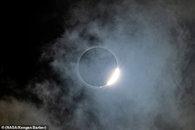 The NASA photo explorer took several high-resolution images of these solar prominences, which were unusually visible thanks to the moon, which had eclipsed all but the sun's white corona and reddish-pink chromosphere.