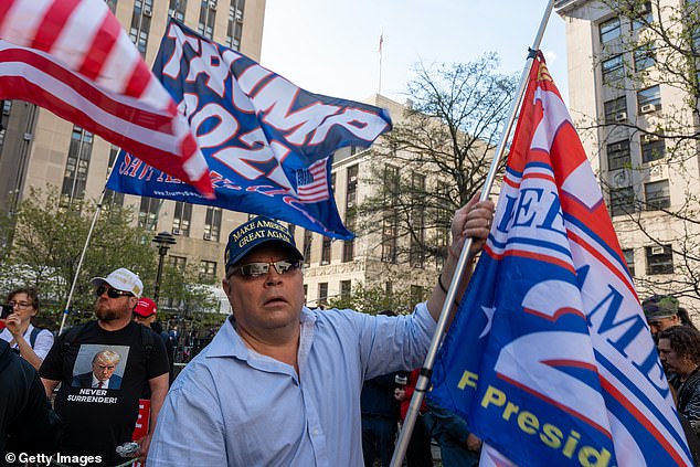 Trump could still run for president in 2024 if convicted of a crime.  Pictured: Trump supporters gather outside the Manhattan Criminal Courthouse on Monday for the start of the former president's criminal trial