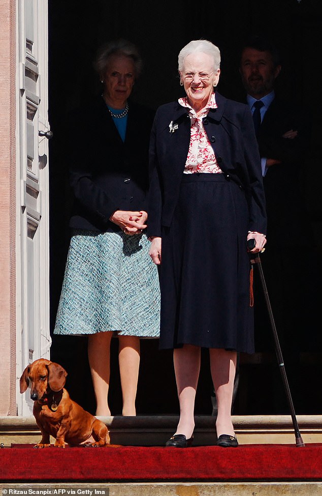 Queen Margrethe smiles next to her beloved pup as she greets royal fans outside Fredensborg Castle ahead of her 84th birthday festivities