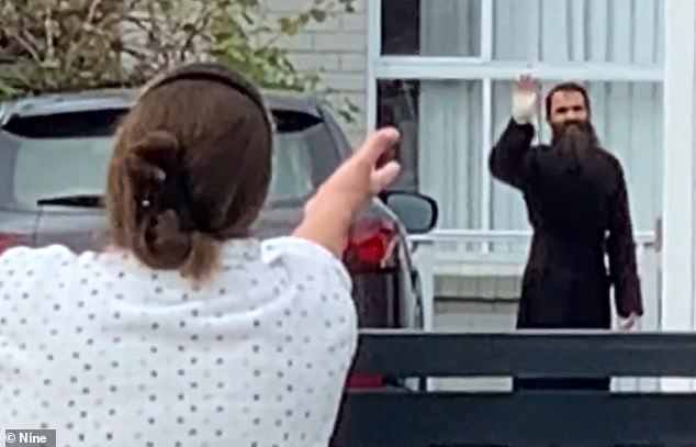 Father Royel was seen walking from the hospital on Wednesday afternoon and waving at an excited neighbor with a bandage wrapped around his hand (photo)