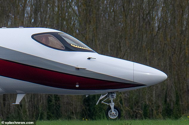 Tom could be seen sitting in the cockpit wearing headphones as he focused on landing the plane during the stormy weather