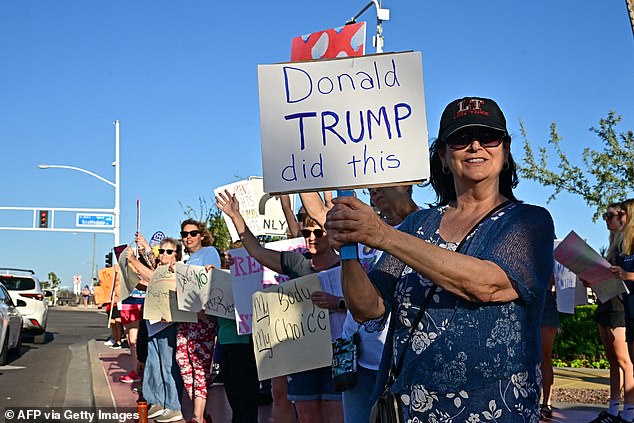 Ab abortion rights protester holds a sign reading 