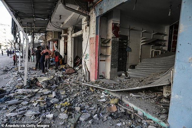 Palestinians gather to inspect a collapsed building after an Israeli attack in the Yibta refugee camp in Rafah, Gaza on April 17, 2024