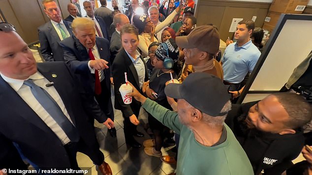 Trump (pictured handing out milkshakes) made a surprise visit to the fast-food restaurant, where he told a dozen employees behind the counter: 