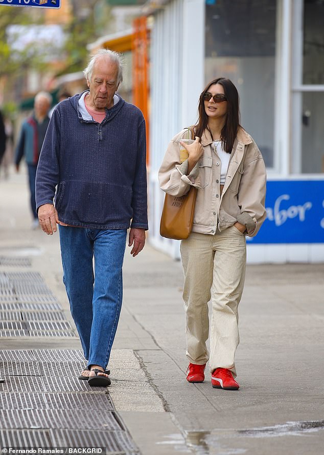 John towered over his 6-foot daughter in blue jeans, flip-flops and a comfy blue sweater