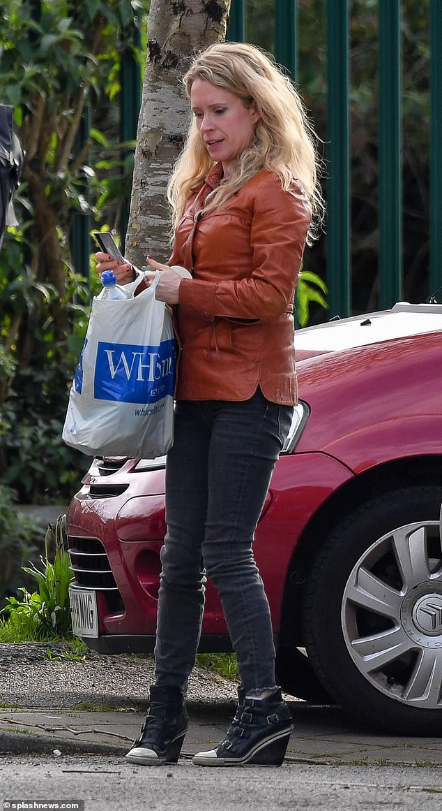 During the outing, Lucy wore a tan jacket with skinny jeans and heeled boots and carried a WHSmith tote bag.