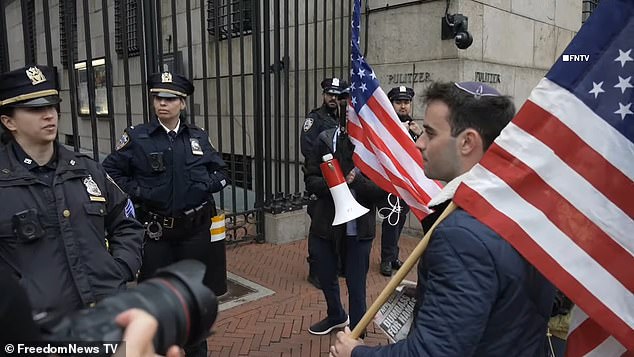 A female NYPD officer (far left) is heard saying, 