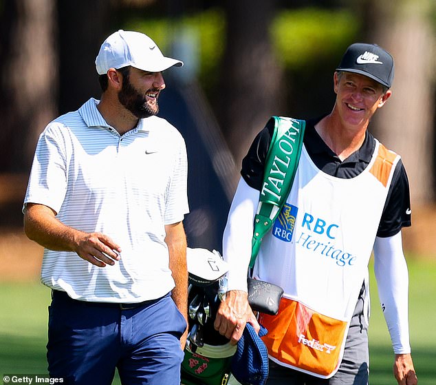 Scheffler smiled as he spoke to his caddy, Ted Scott, as he walked the second hole