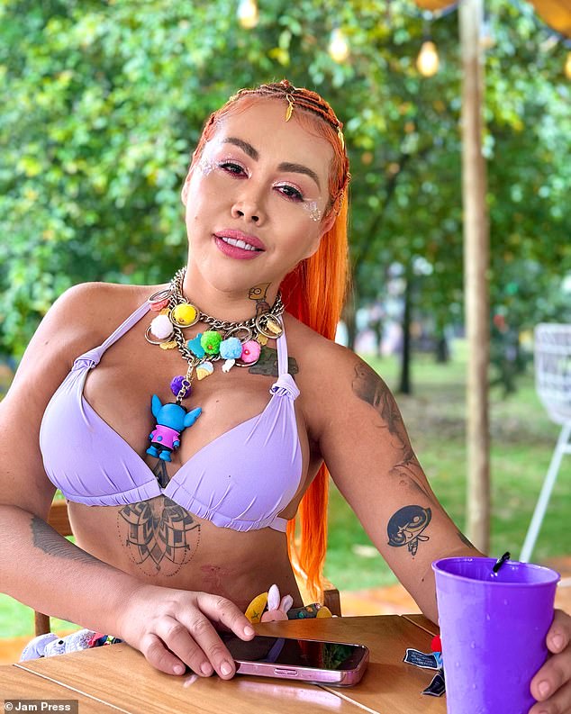 The Colombian beauty is also famous for her numerous plastic surgeries.  Pictured above, she wears a lilac bikini and holds a matching purple cup, with tattoos across her upper body