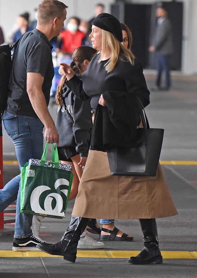 She wore a black beret, pearl earrings and a pair of knee-high boots