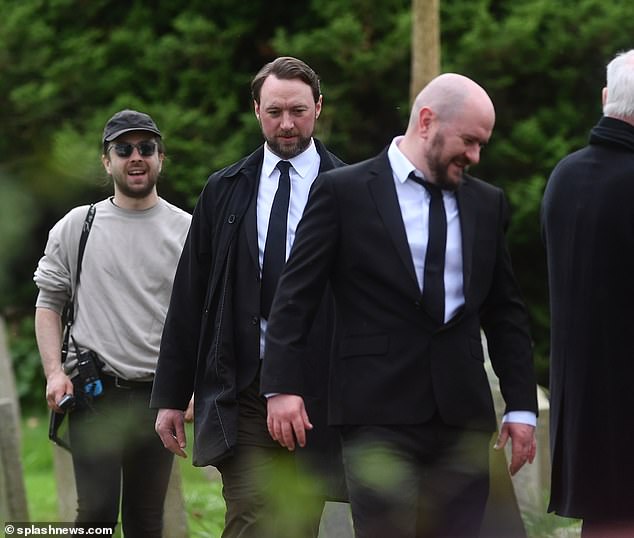 But when she returns for the service later in the day, she sees Dr Liam Cavanagh (Jonny McPherson) (left) and Simon Naylor's character, whose name has not been revealed, along with other mourners paying their respects to the woman.