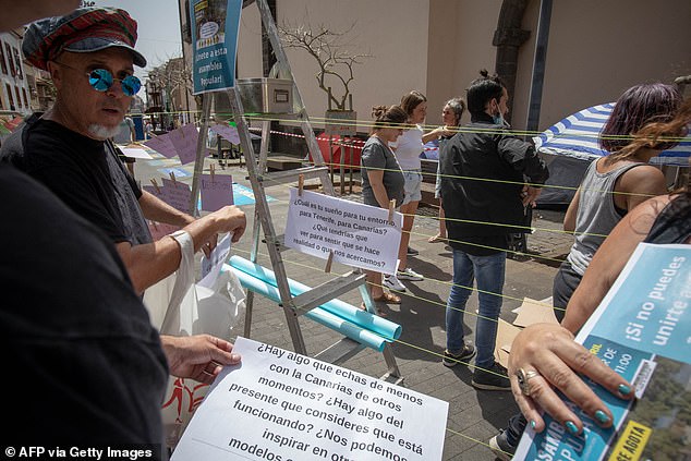 Members of the movement 'Canaria se agota' ('Canaria is exhausted') take part in a protest against the construction of a hotel near La Tejita playa and other mass tourism infrastructure, on April 13, 2024