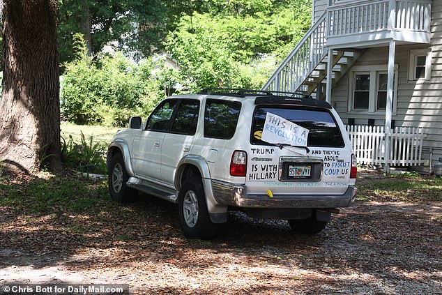 After his death, Azzarello's white Toyota 4Runner truck sits where he left it outside his apartment building.  “Trump is with Hillary, and they're about to let the fascists cut us down” is written in permanent marker on the back