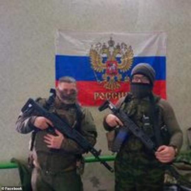 Stimson (left) is pictured on the front line, dressed in Russian uniforms and posing in front of a Russian flag