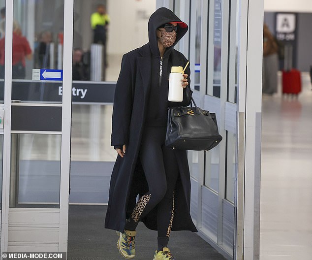 The 33-year-old further hid her identity in a long black coat and matching PE Nation hoodie.  The pop star also wore tights with a leopard print on the side