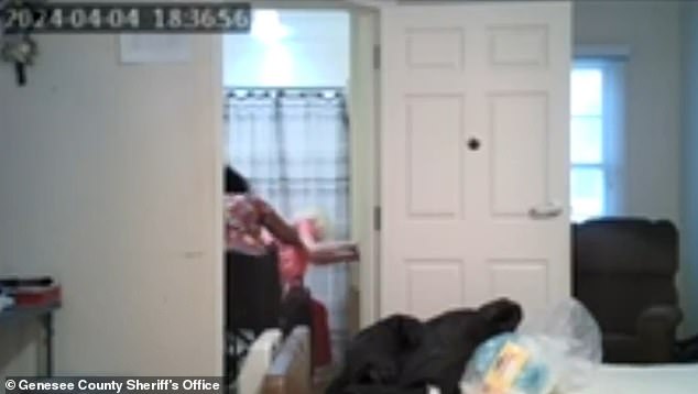 Footage shows Arrington repeatedly slapping a full diaper over the victim's head as she sits helplessly in her wheelchair and raises her arms in defense