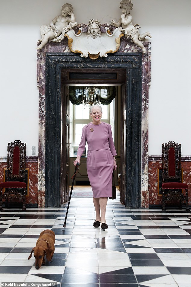 The second photo shows the former monarch walking along the monochrome tiled floor of Fredensborg Castle, next to her sausage dog Tilia