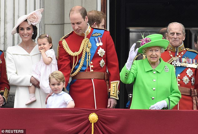 Queen Elizabeth and her husband Prince Philip, who died a year before her, are photographed during Trooping the color in 2016 with Kate, William, Charlotte and George