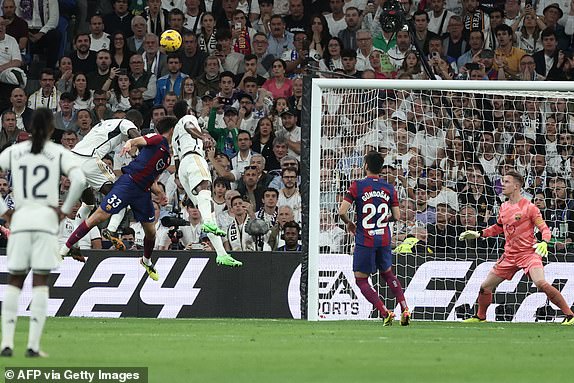 Real Madrid's German defender No. 22 Antonio Rudiger (above L), Barcelona's Spanish defender No. 33 Pau Cubarsi (above C) and Real Madrid's Brazilian striker No. 07 Vinicius Junior compete for a header during the Spanish league match between Real Madrid CF and FC Barcelona at the Santiago Bernabeu Stadium in Madrid on April 21, 2024. (Photo by Thomas COEX / AFP) (Photo by THOMAS COEX/AFP via Getty Images)