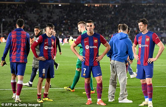 Barcelona's Spanish midfielder No. 08 Pedri, Barcelona's Spanish striker No. 07 Ferran Torres and Barcelona's Polish striker No. 09 Robert Lewandowski react at the end of the quarter-final of the UEFA Champions League football match between FC Barcelona and Paris SG at the Estadi Olimpic Lluis Companys in Barcelona on April 16, 2024. (Photo by Josep LAGO/AFP) (Photo by JOSEP LAGO/AFP via Getty Images)