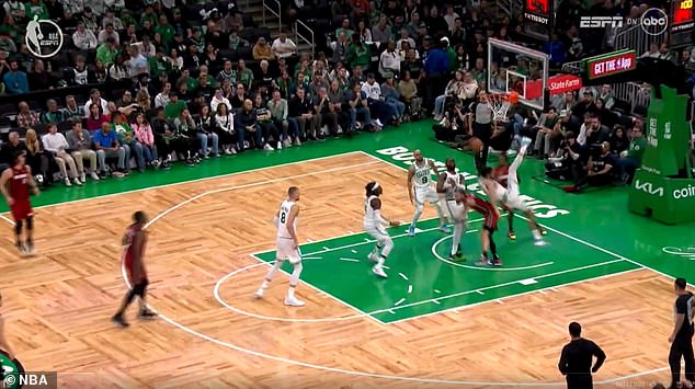 The Heat forward crashed into the paint for a rebound as Tatum faced the hoop