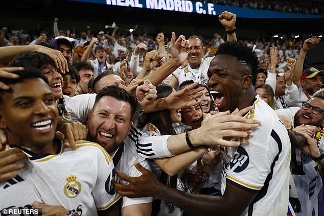 Vinicius Jr celebrates with Madrid supporters after Bellingham's winning goal