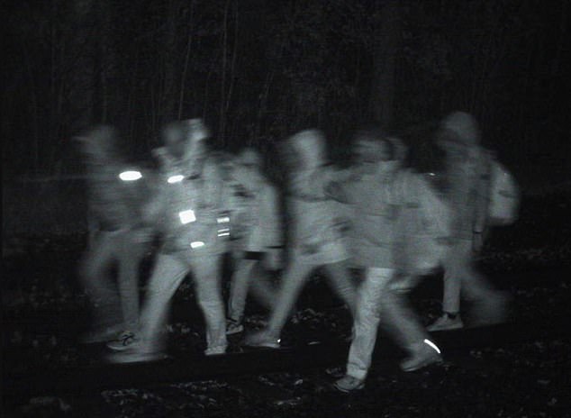 Border Patrol footage shows a group of people crossing the Canadian border into the US