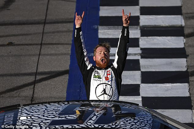 Reddick celebrates with his car at the track after winning the NASCAR Cup Series GEICO 500
