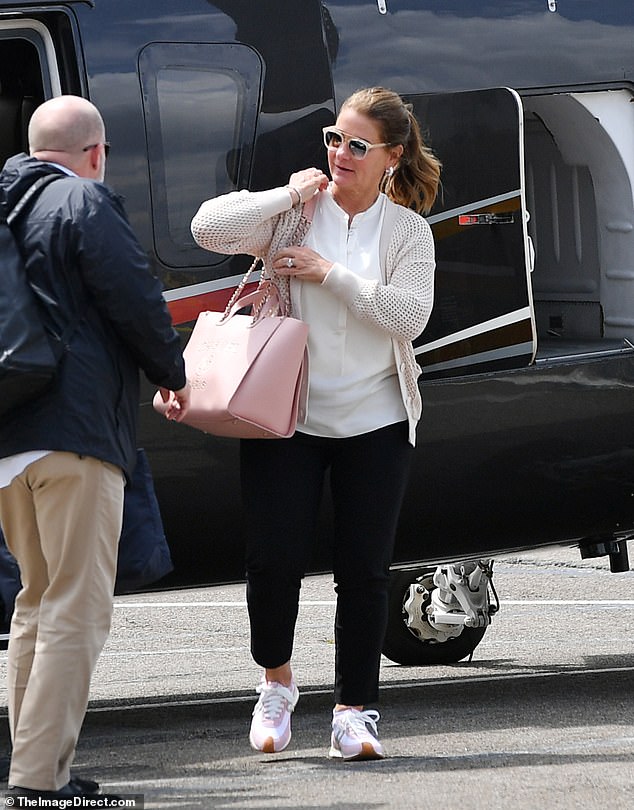 Melinda carried a pink Chanel bag and wore a mesh jacket, white blouse, black pants and Loewe sneakers
