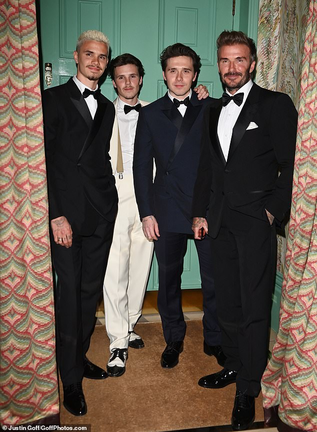 Earlier that evening, David posed for a group photo with his three sons