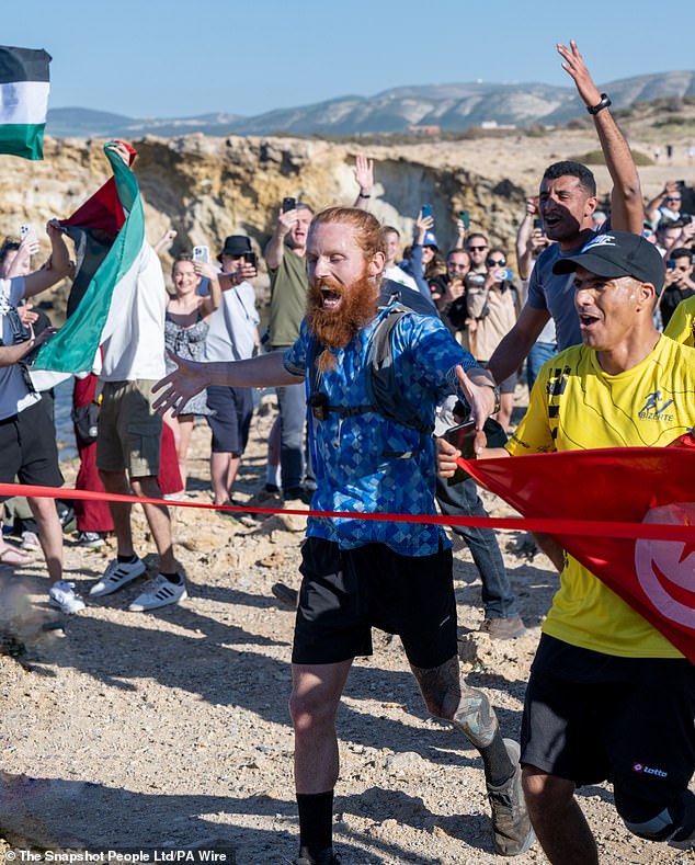 Russ was seen crossing the finish line at Ras Angela, Tunisia's northernmost point, after running the equivalent of 385 marathons in 352 days