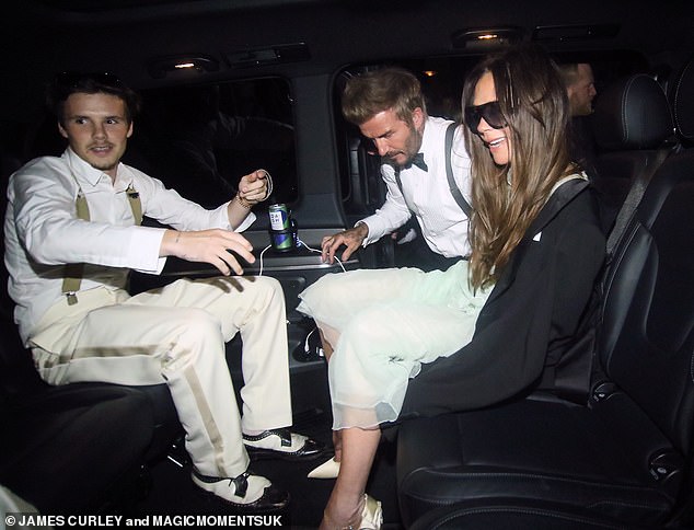 Victoria looked cheerful as David helped his wife into the back of a waiting car after the party