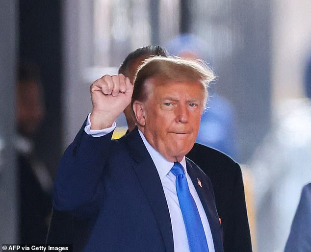 The 77-year-old waved and raised his fist at photographers and onlookers as he walked down the sidewalk of Trump Tower and climbed into his waiting SUV.