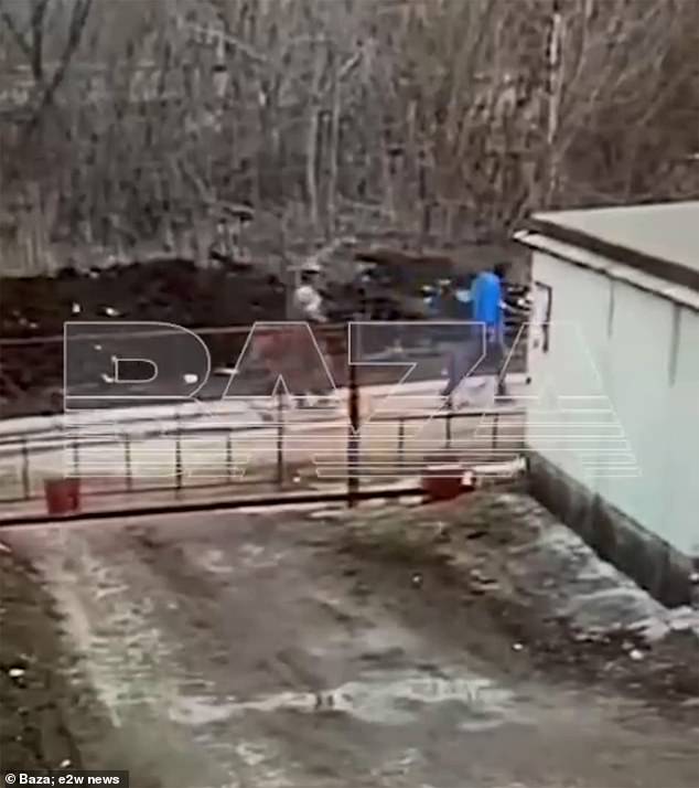 Khammatov wears blue in video footage of the troops leading him away