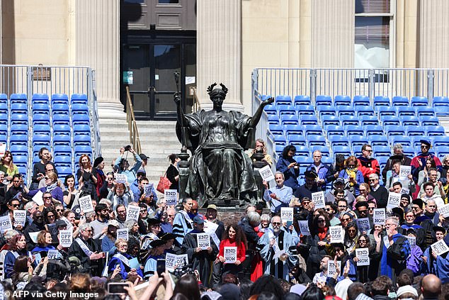 Employees held signs reading: 'Hands off our students' as they protested the school's decision to suspend several anti-Israel protesters