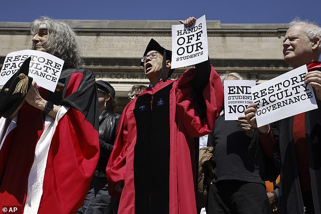 Employees held signs that read: 'Hands off our students' and 'End student suspension'