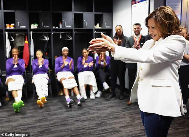 U.S. Vice President Kamala Harris (R) speaks with members of the Phoenix Mercury WNBA team in May 2022