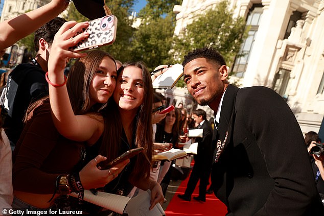 Bellingham stopped for photos with adoring fans before entering Madrid's Galeria de Cristal