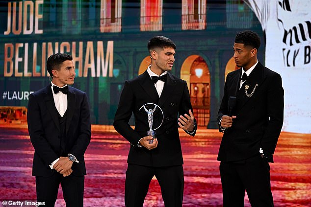 Bellingham was presented with his award during the ceremony on Monday evening by Grand Slam champion Carlos Alcaraz (center) and Laureus ambassador Marc Marquez (left)