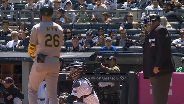 Umpire Hunter Wendelstedt thought the abuse from the fan in blue (center) came from Boone