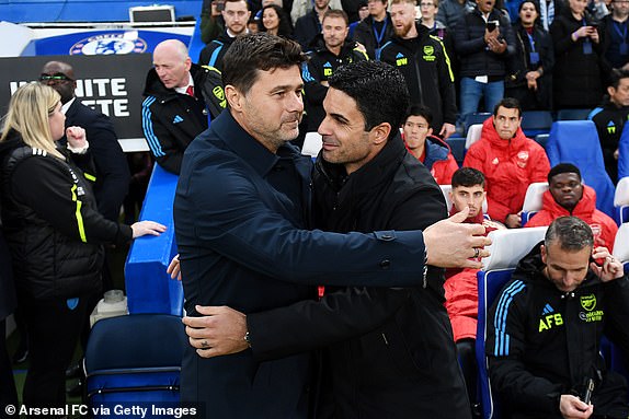 LONDON, ENGLAND – OCTOBER 21: Chelsea Manager Mauricio Pochettino hugs Arsenal Manager Mikel Arteta ahead of the Premier League match between Chelsea FC and Arsenal FC at Stamford Bridge on October 21, 2023 in London, England.  (Photo by Stuart MacFarlane/Arsenal FC via Getty Images)