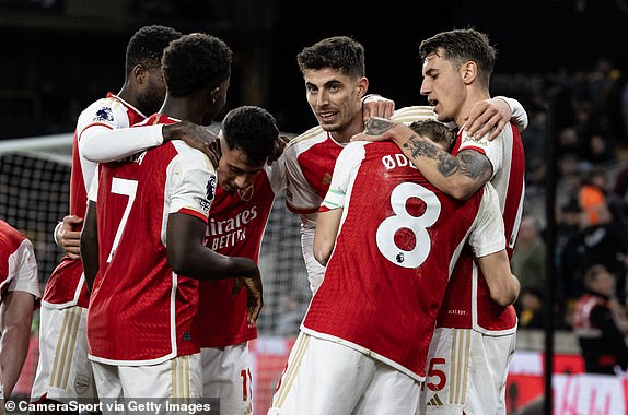 WOLVERHAMPTON, ENGLAND - APRIL 20: Arsenal's 2nd goalscorer Martin Odegaard (#8) is congratulated by teammates Kai Havertz (center) and Jakub Kiwior (right) during the Premier League match between Wolverhampton Wanderers and Arsenal FC at Molineux on April 20, 2024 in Wolverhampton, England.  (Photo by Andrew Kearns - CameraSport via Getty Images)