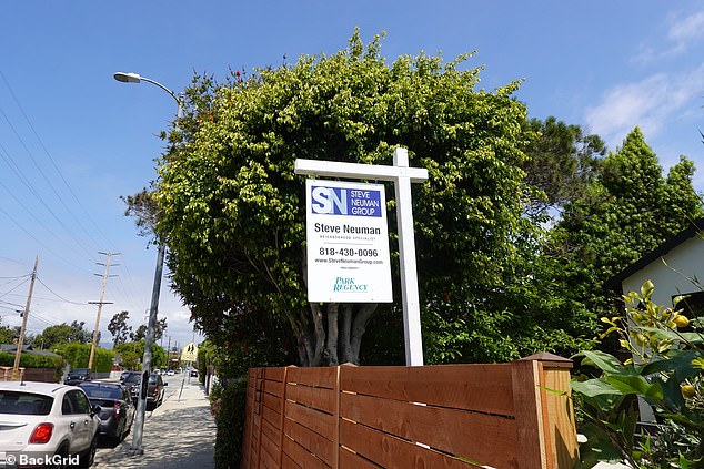 A real estate agent's face could be seen near a fence on the property in Mar Vista, California