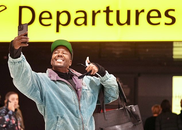 After taking a selfie at the departure board, Vas was photographed confidently maneuvering his luggage through the airport