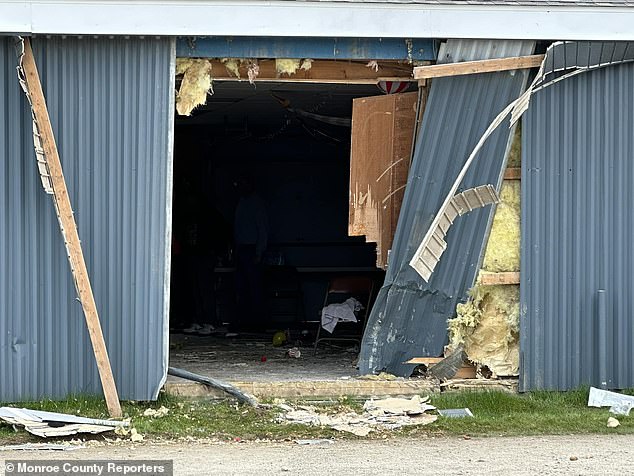 Horrifying footage showed scattered balloons and party cups after a drunk driver crashed into a children's birthday party, killing two young siblings and leaving at least nine victims fighting for their lives (photo: Broken wall at the venue)