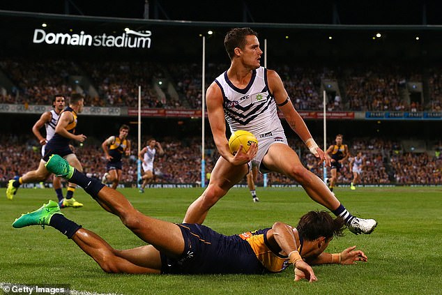 Balic (pictured centre, playing for Fremantle against West Coast) announced his immediate retirement from the sport in August 2018
