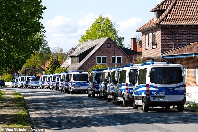 Scores of emergency vehicles are parked along a road in the town of Elm, Lower Saxony, as hundreds of police and firefighters desperately try to locate the boy.