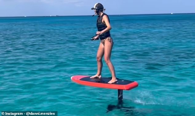 Danni even tried his hand at surfing, wearing leopard print bikini bottoms, and showed off her incredible balancing skills on an electric surfboard eFoil