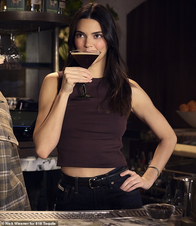 Jenner – who was dressed in a chocolate brown crop top that showed off a hint of her toned stomach – emphasized that the martini is best with tequila