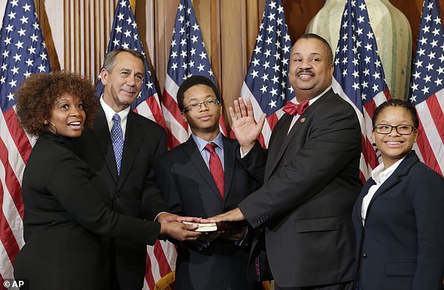 The late Rep. Donald Payne Jr.  stands with his family for a ceremonial photo with former Speaker of the House of Representatives John Boehner during his swearing-in ceremony in 2013